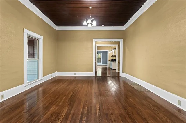 a view of a room with wooden floor a ceiling fan and window