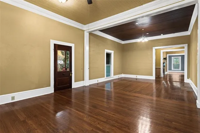 a view of an empty room with wooden floor