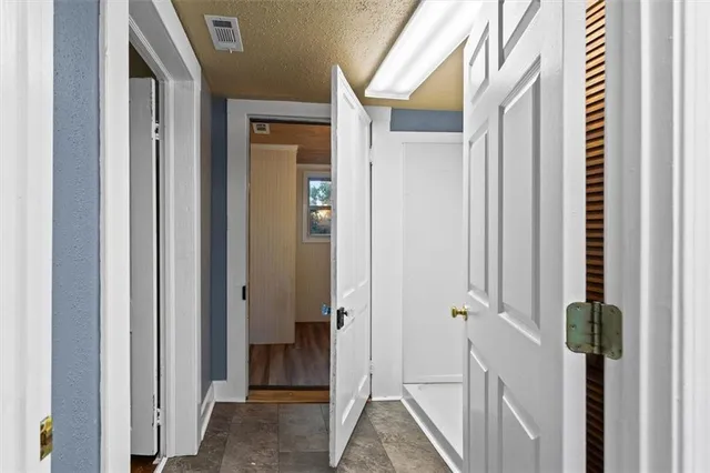 a bathroom with a bathtub shower sink vanity and toilet