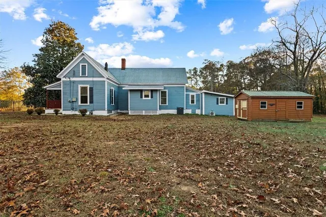 a front view of house with yard and trees