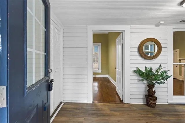 a view of a hallway with wooden floor