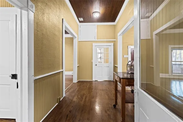 a view of a hallway with wooden floor and staircase