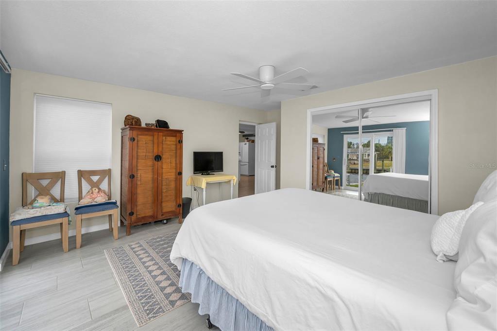 5433 Bluepoint Drive Port Richey, FL 34668 - Photo 12 of 50 a spacious bedroom with a bed and a large mirror