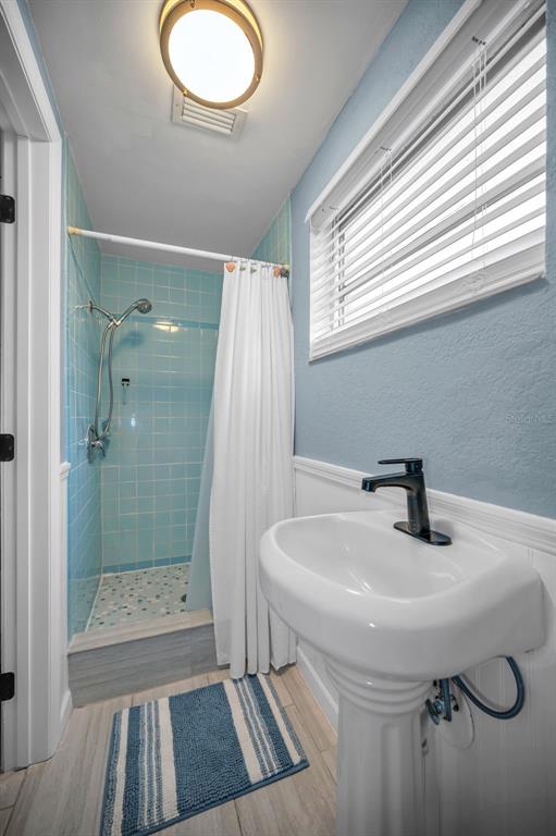 5433 Bluepoint Drive Port Richey, FL 34668 - Photo 15 of 50 a bathroom with a sink a toilet a mirror and shower