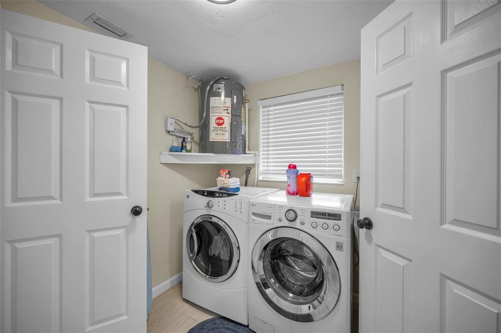 5433 Bluepoint Drive Port Richey, FL 34668 - Photo 20 of 50 a utility room with dryer and washer