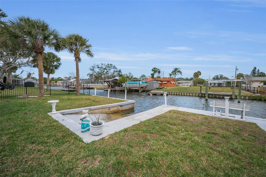 5433 Bluepoint Drive Port Richey, FL 34668 - Photo 23 of 50 a view of a swimming pool with lawn chairs and a big yard