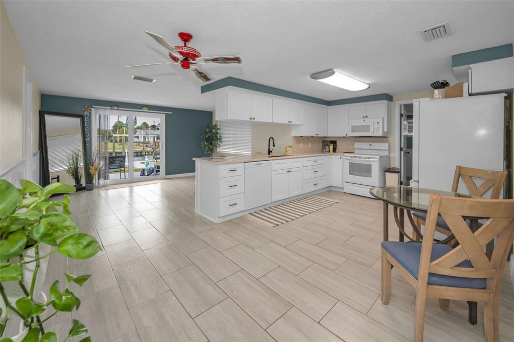 5433 Bluepoint Drive Port Richey, FL 34668 - Photo 3 of 50 a kitchen with a table and chairs in it