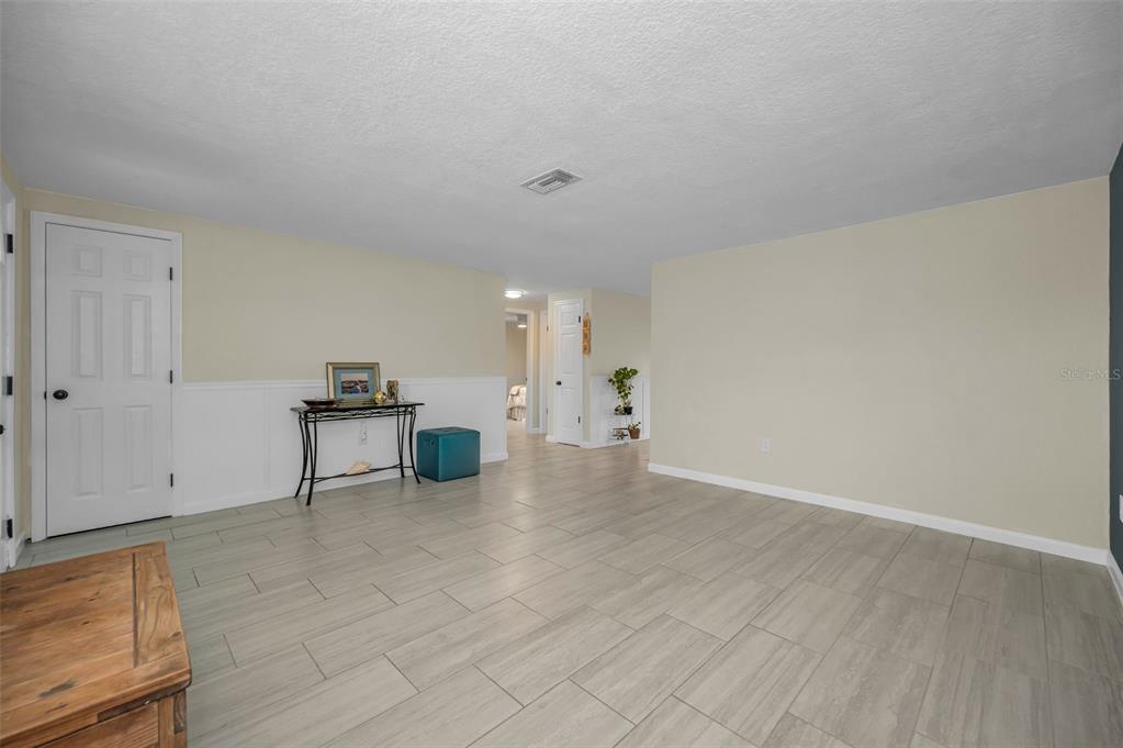 5433 Bluepoint Drive Port Richey, FL 34668 - Photo 4 of 50 a view of empty room with wooden floor