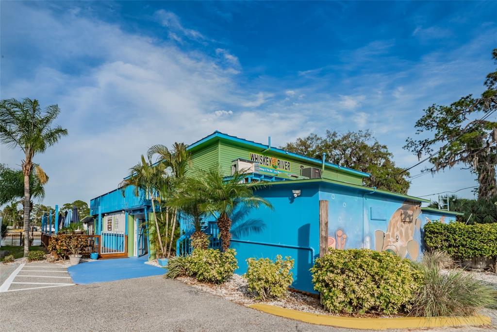 5433 Bluepoint Drive Port Richey, FL 34668 - Photo 47 of 50 a front view of a house with garden