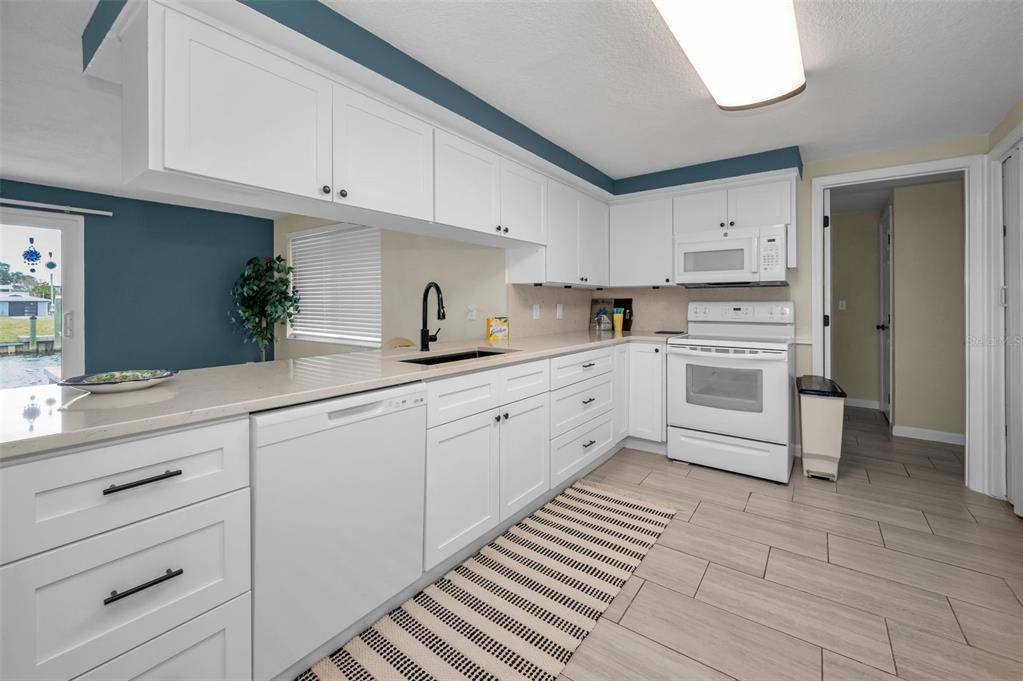 5433 Bluepoint Drive Port Richey, FL 34668 - Photo 8 of 50 a kitchen with cabinets stainless steel appliances a sink and cabinets