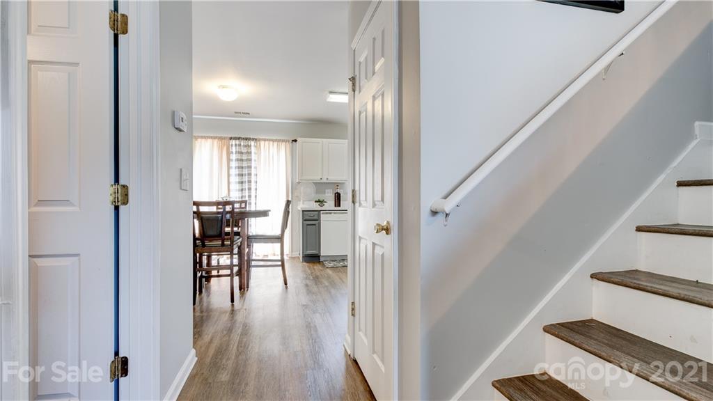 7103 Indian Ridge Lane Charlotte, NC 28214 - Photo 14 of 24 a view of a hallway with wooden floor and dining room
