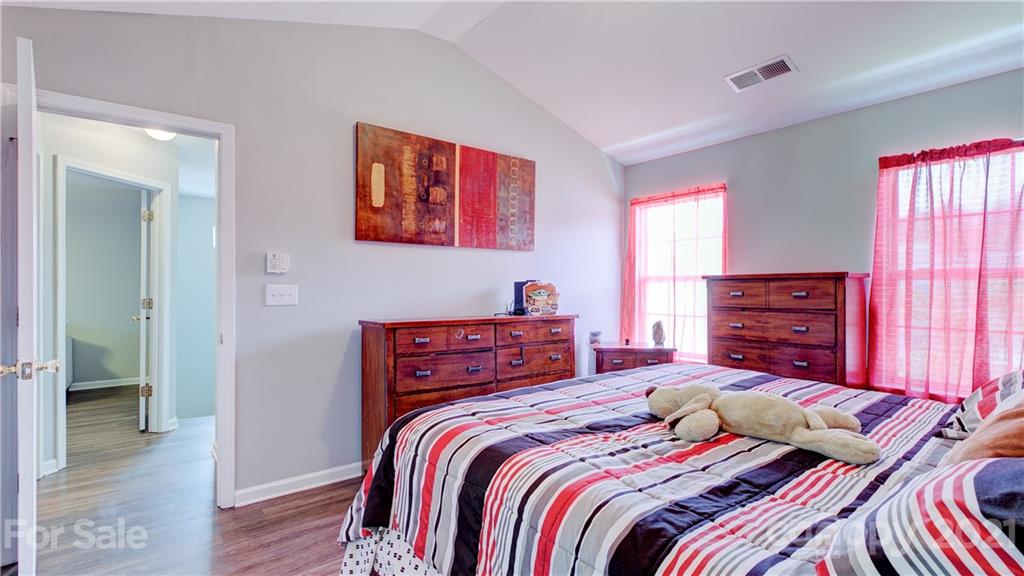 7103 Indian Ridge Lane Charlotte, NC 28214 - Photo 18 of 24 a bedroom with a bed and wooden floor