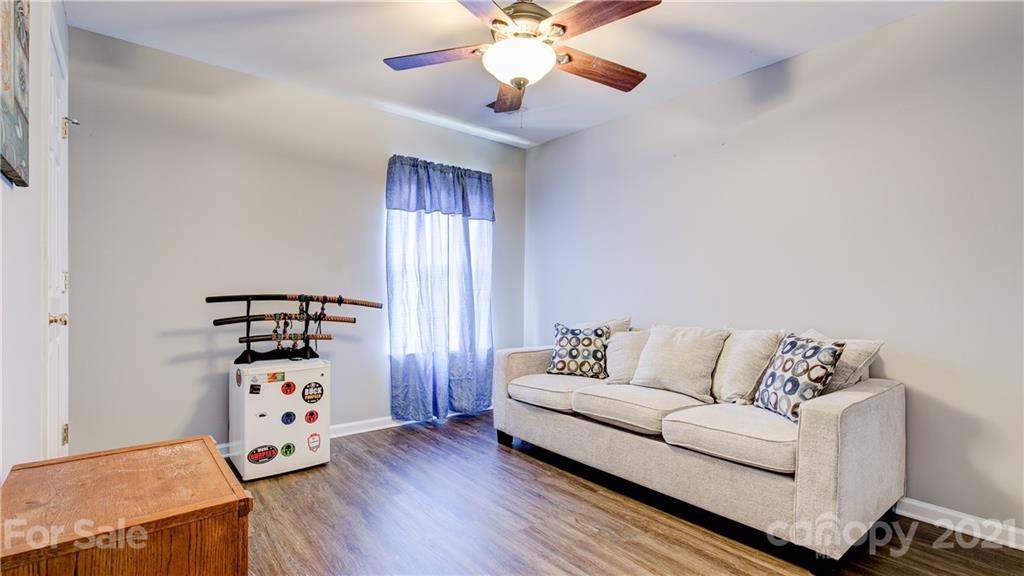 7103 Indian Ridge Lane Charlotte, NC 28214 - Photo 22 of 24 a living room with furniture and chandelier