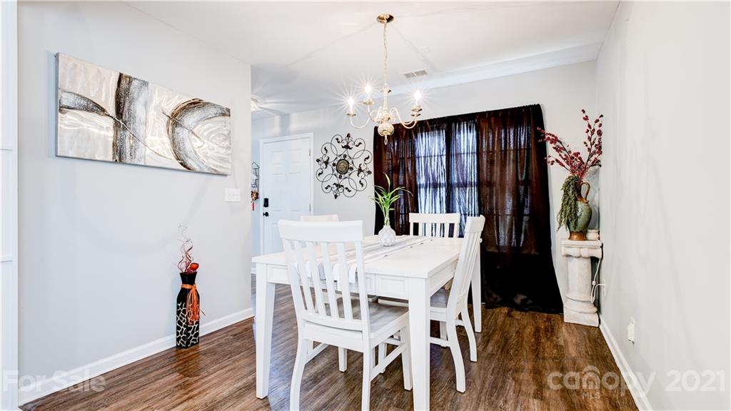 7103 Indian Ridge Lane Charlotte, NC 28214 - Photo 5 of 24 a view of a dining room with furniture and wooden floor