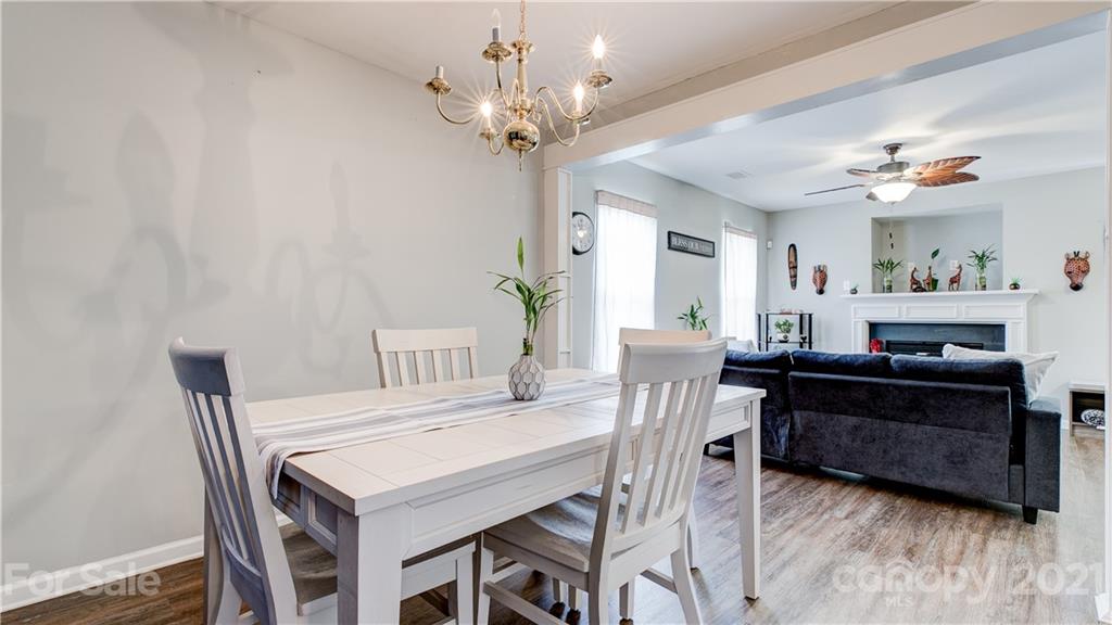 7103 Indian Ridge Lane Charlotte, NC 28214 - Photo 6 of 24 a view of a dining room with furniture and chandelier