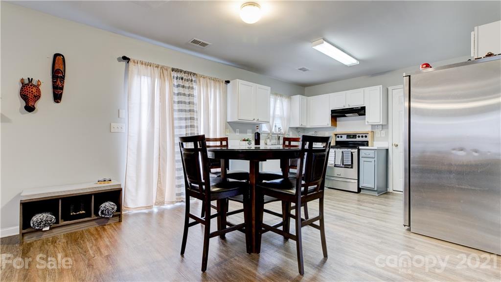 7103 Indian Ridge Lane Charlotte, NC 28214 - Photo 8 of 24 a view of a dining room with furniture and a window