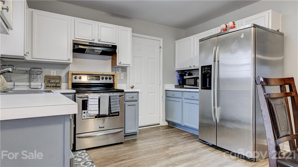 7103 Indian Ridge Lane Charlotte, NC 28214 - Photo 9 of 24 a kitchen with stainless steel appliances and refrigerator