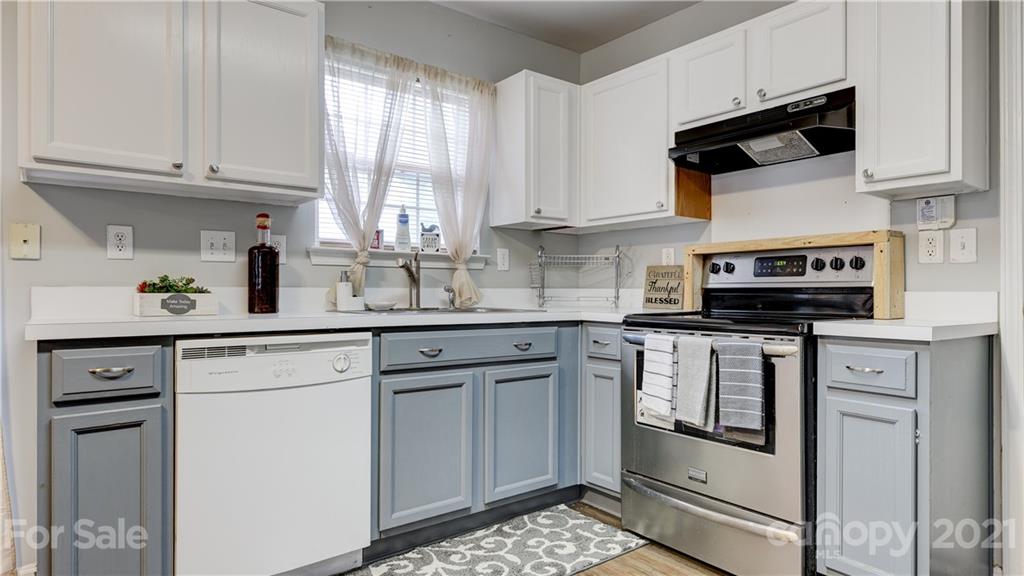 7103 Indian Ridge Lane Charlotte, NC 28214 - Photo 10 of 24 a kitchen with stainless steel appliances granite countertop white cabinets granite counter tops and a window