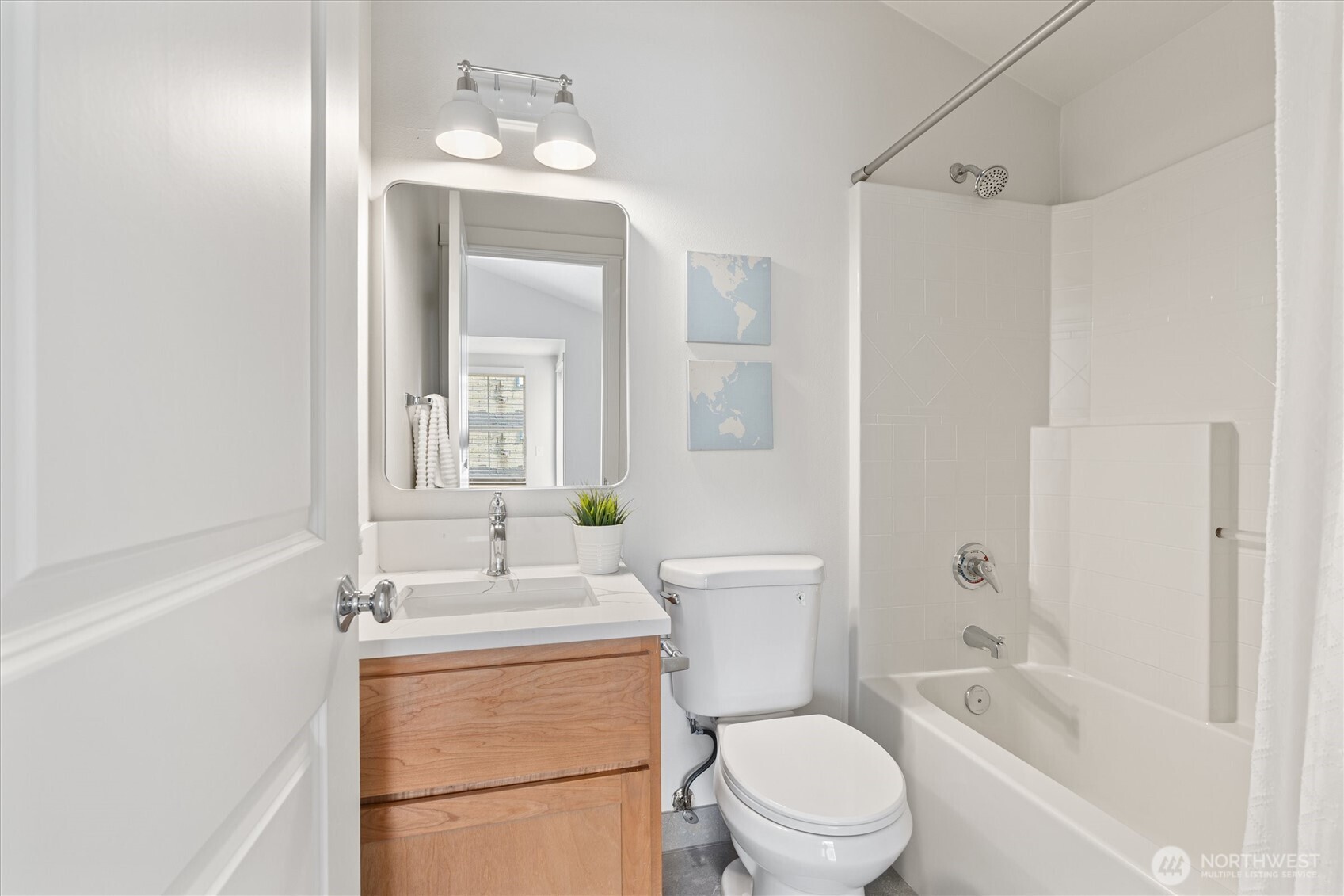 10311 Midvale Avenue North, Unit A Seattle, WA 98133 - Photo 13 of 19 a bathroom with a toilet a sink and a bathtub