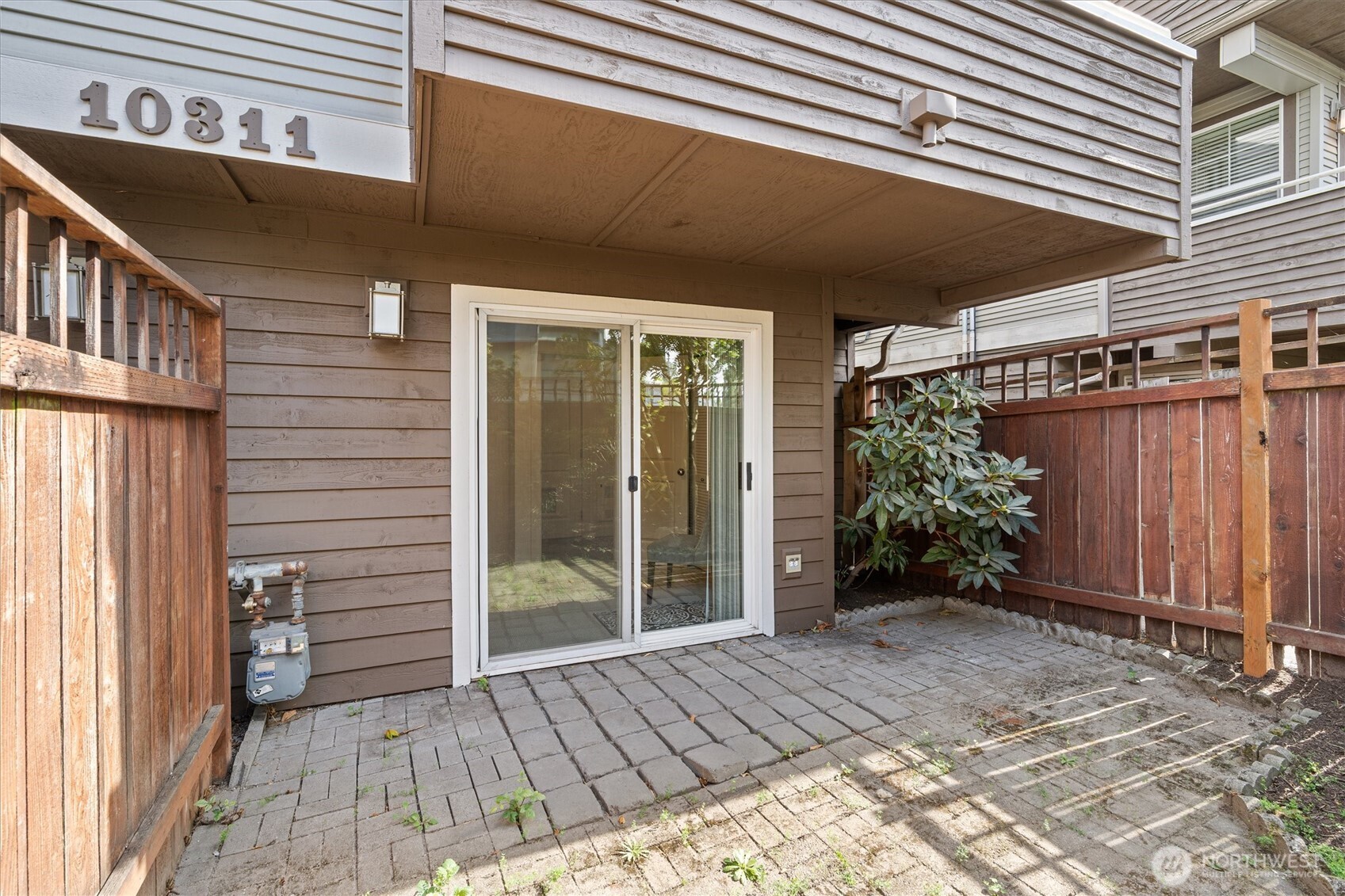 10311 Midvale Avenue North, Unit A Seattle, WA 98133 - Photo 16 of 19 a view of a house with door and wooden walls