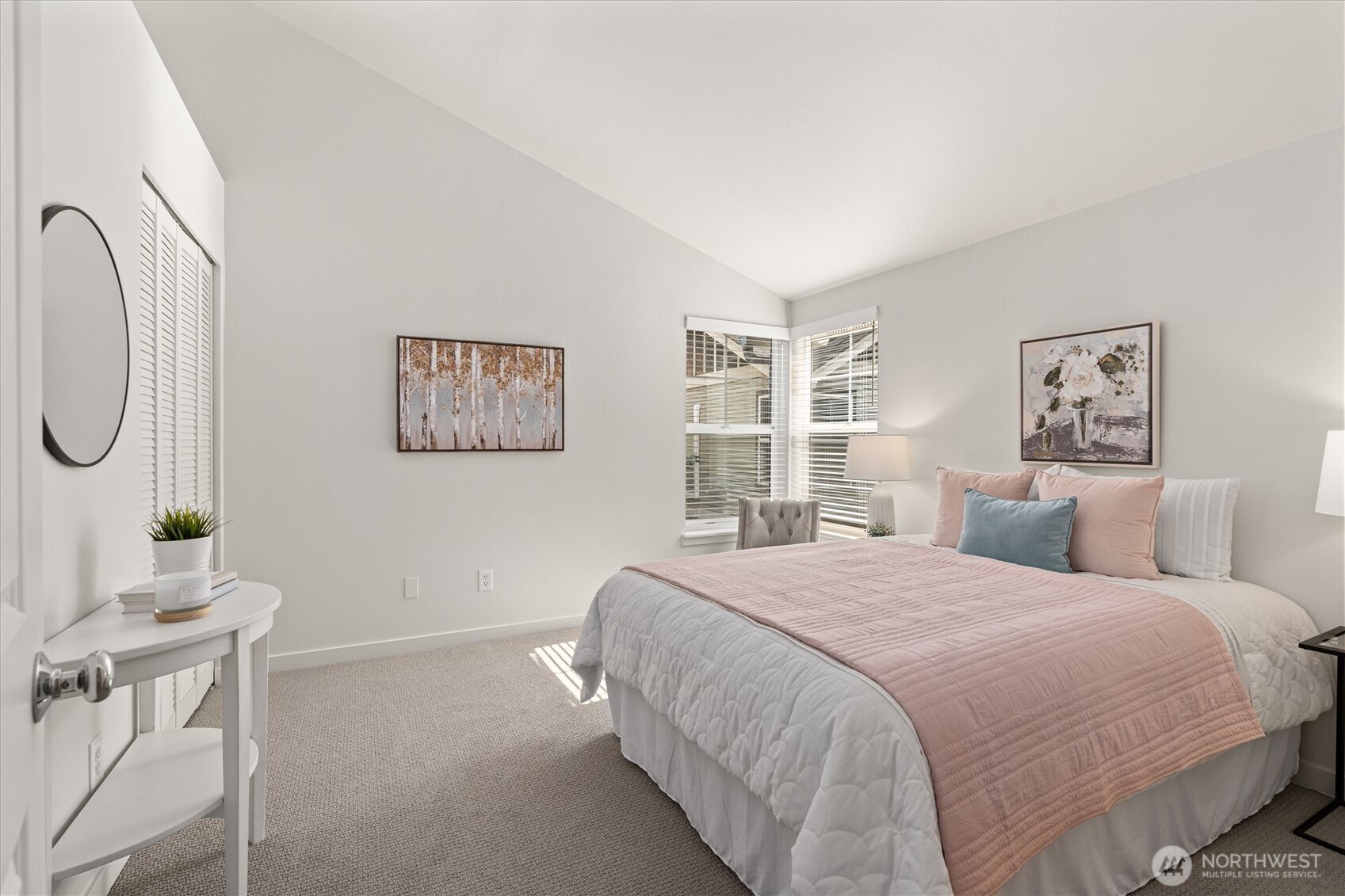 10311 Midvale Avenue North, Unit A Seattle, WA 98133 - Photo 8 of 19 a bedroom with a bed a mirror and a window