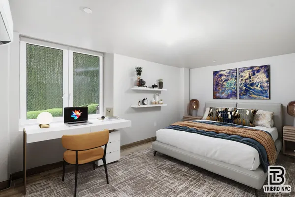 a bedroom with a bed a large window and a potted plant