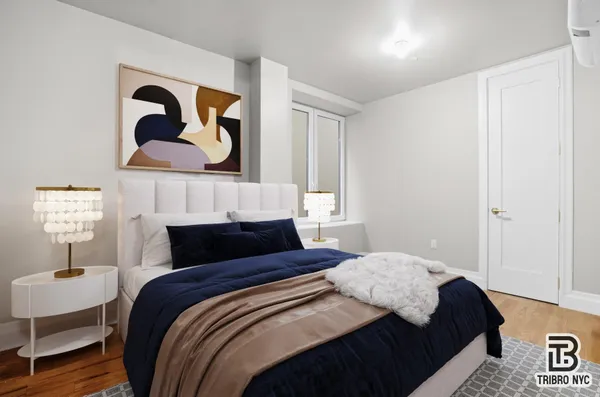 a bedroom with a bed and painting on the wall