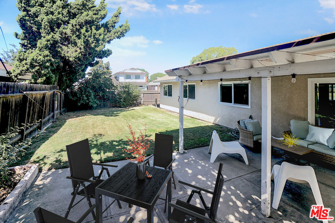 8251 Acacia Street Cypress, CA 90630 - Photo 12 of 13 a view of a patio with table and chairs and potted plants