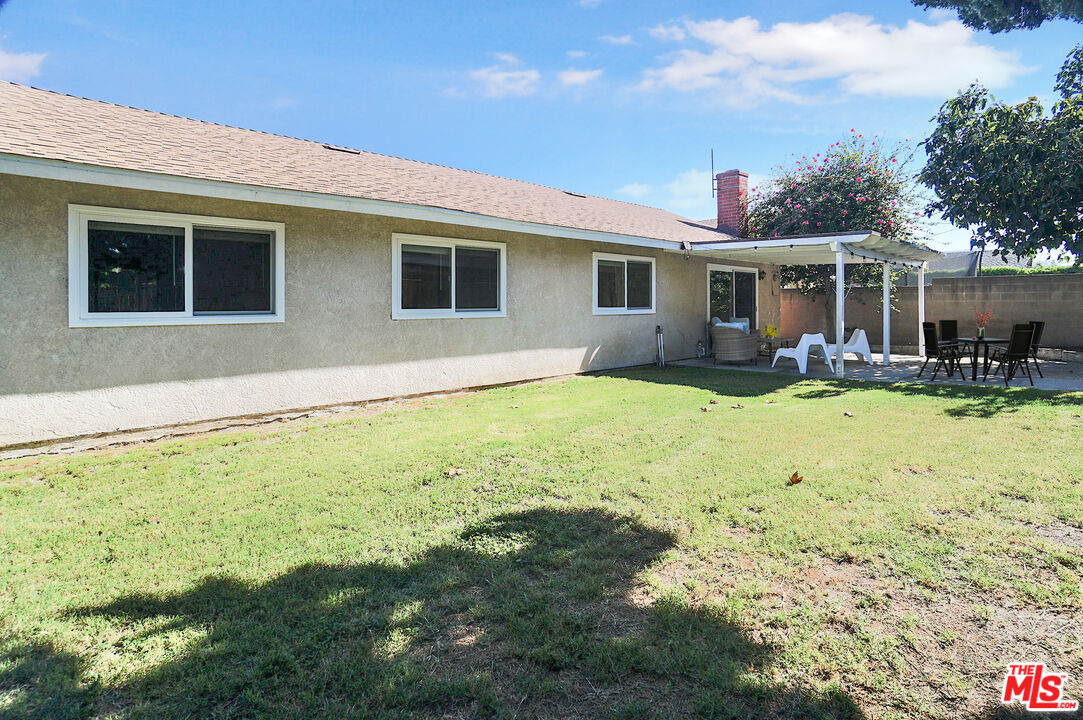 8251 Acacia Street Cypress, CA 90630 - Photo 13 of 13 a backyard of a house with yard table and chairs