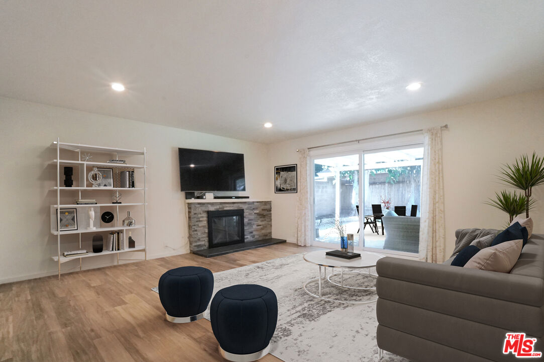 8251 Acacia Street Cypress, CA 90630 - Photo 4 of 13 a living room with furniture and a flat screen tv