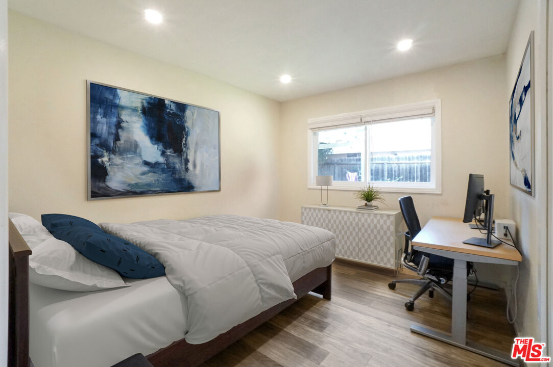 8251 Acacia Street Cypress, CA 90630 - Photo 7 of 13 a bedroom with a bed and a table