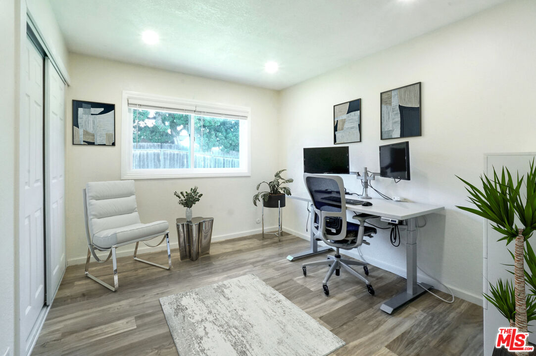 8251 Acacia Street Cypress, CA 90630 - Photo 8 of 13 a view of a workspace with furniture and a window