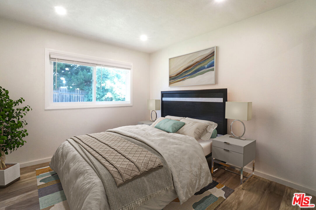 8251 Acacia Street Cypress, CA 90630 - Photo 9 of 13 a bedroom with a bed and a window