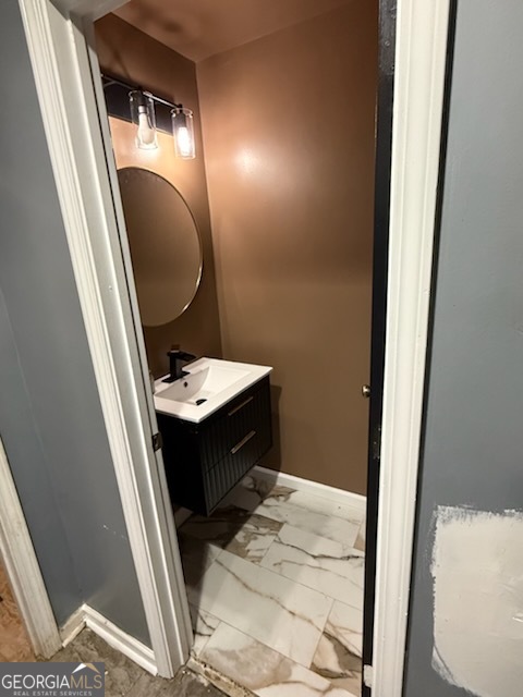 7402 Walton Hill Fairburn, GA 30213 - Photo 5 of 11 a bathroom with a sink a toilet a mirror and vanity