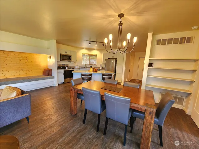 a view of a dining room with furniture and wooden floor