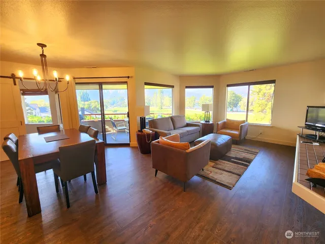 a living room with furniture fireplace and a large window