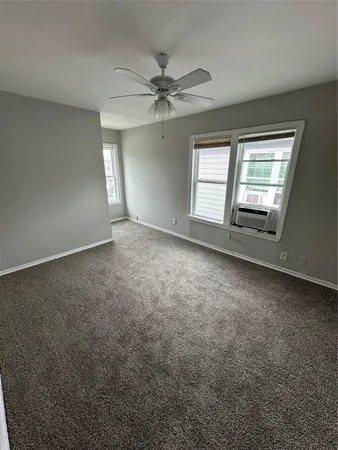 an empty room with a empty space and windows