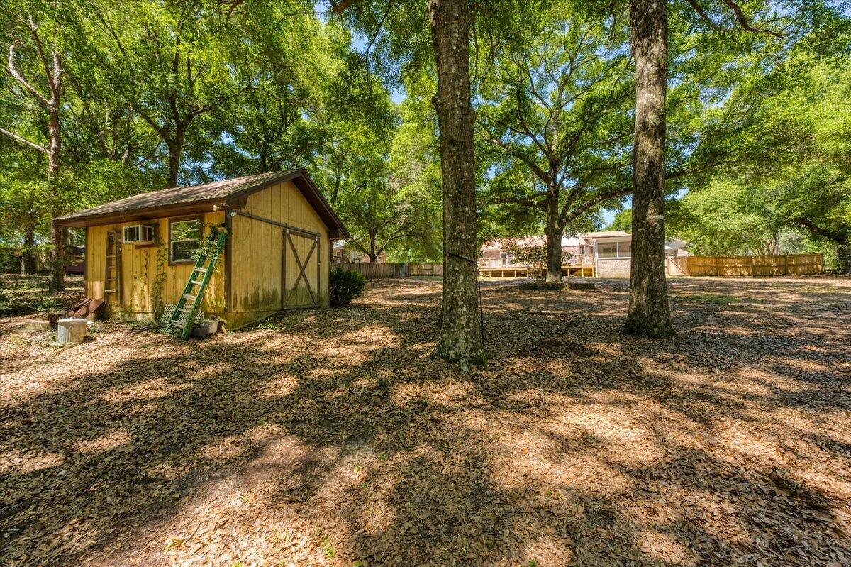 210 Shell Drive Crestview, FL 32536 - Photo 52 of 67 a view of a house with backyard and trees