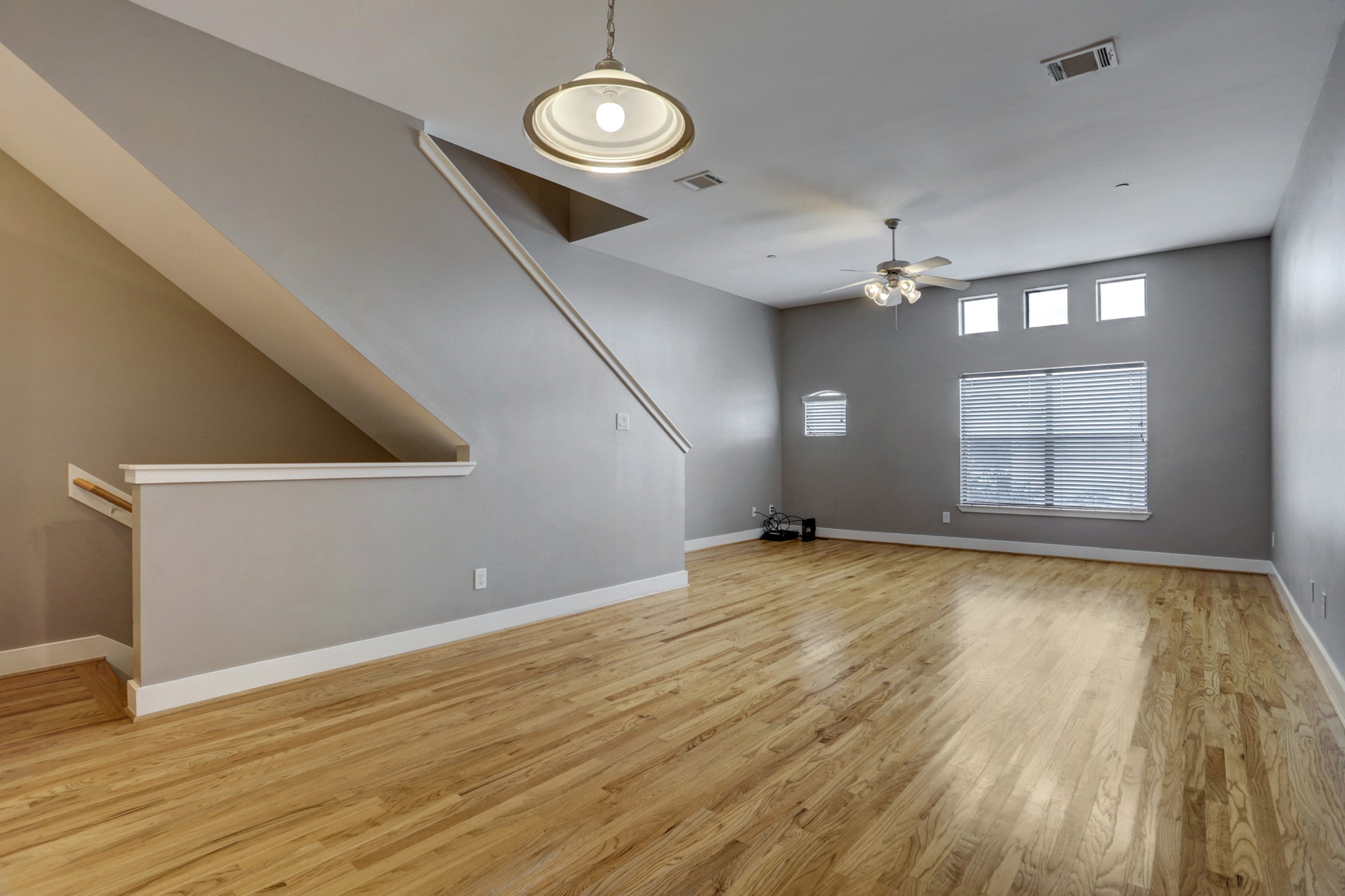 7650 Springhill Street, Unit 304 Houston, TX 77021 - Photo 4 of 18 an empty room with wooden floor and windows