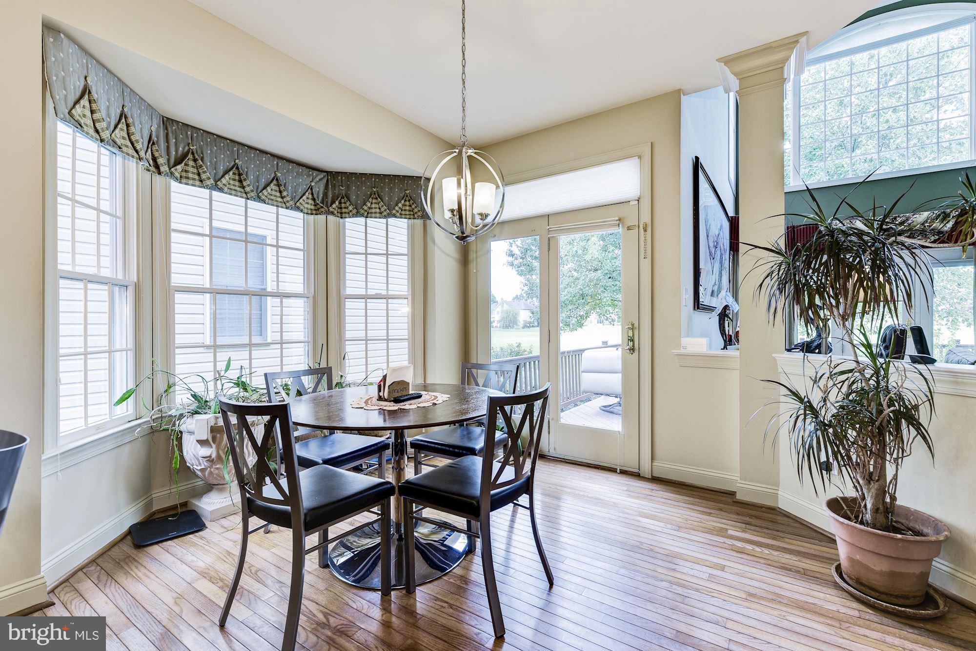 126 Augusta Drive Moorestown, NJ 08057 - Photo 12 of 33 a dining room with furniture potted plants and wooden floor