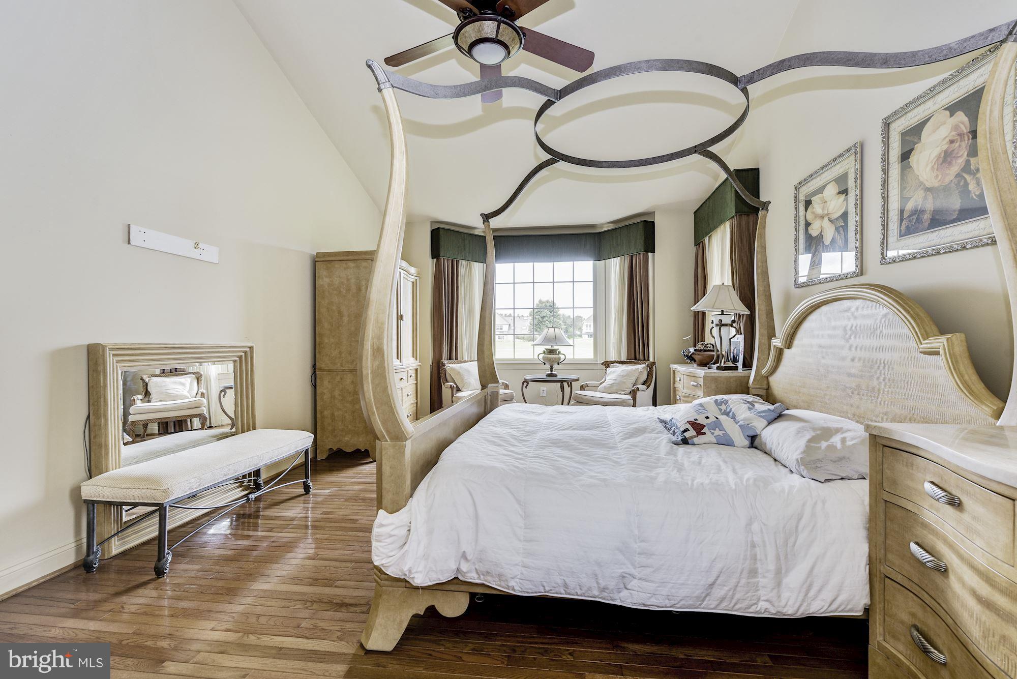 126 Augusta Drive Moorestown, NJ 08057 - Photo 18 of 33 a bed room with a bed mirror and a chandelier