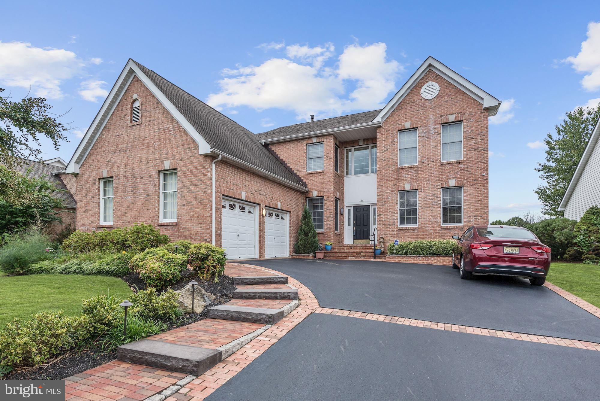 126 Augusta Drive Moorestown, NJ 08057 - Photo 32 of 33 a front view of a house with a garden and parking