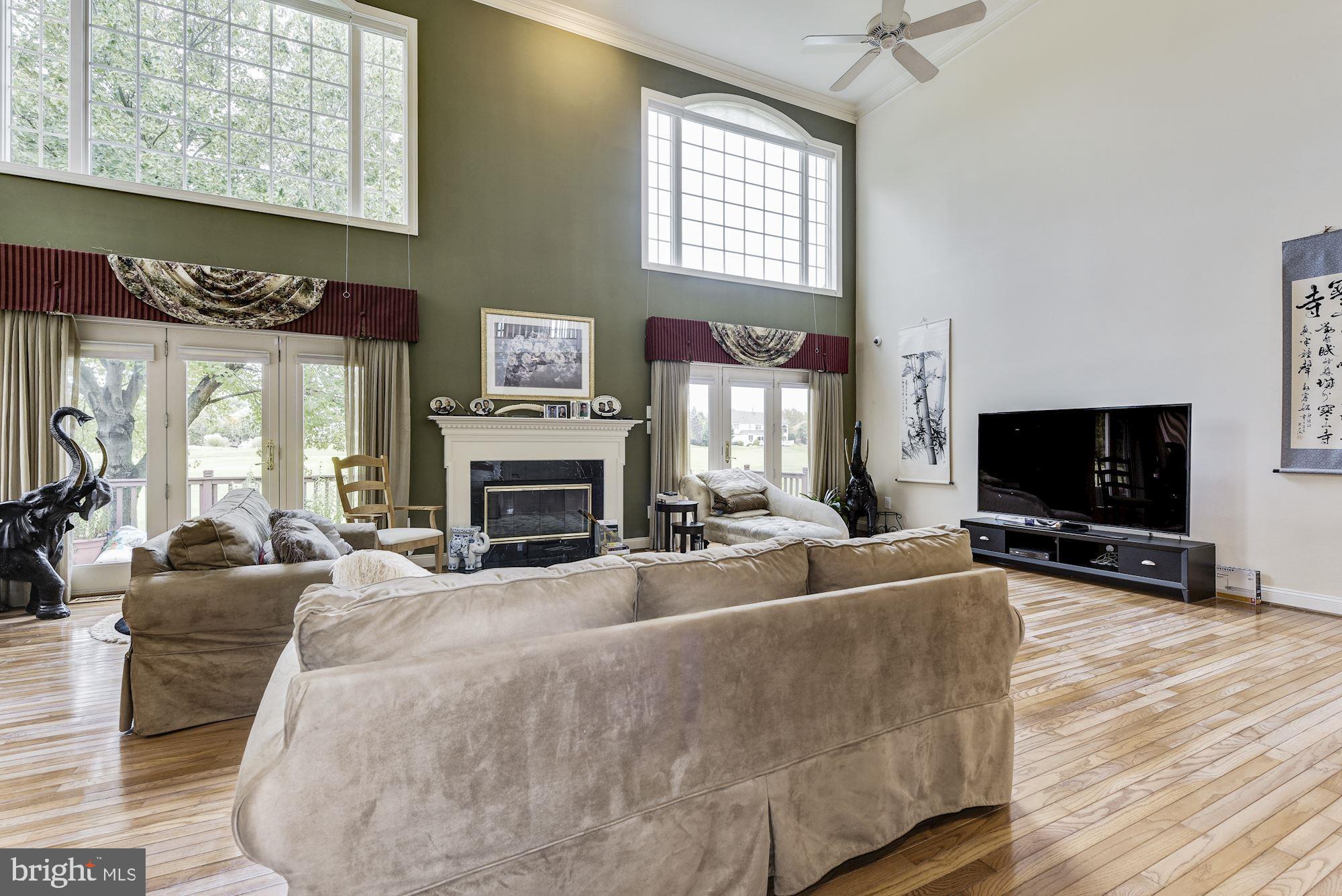 126 Augusta Drive Moorestown, NJ 08057 - Photo 6 of 33 a living room with furniture a flat screen tv and a fireplace