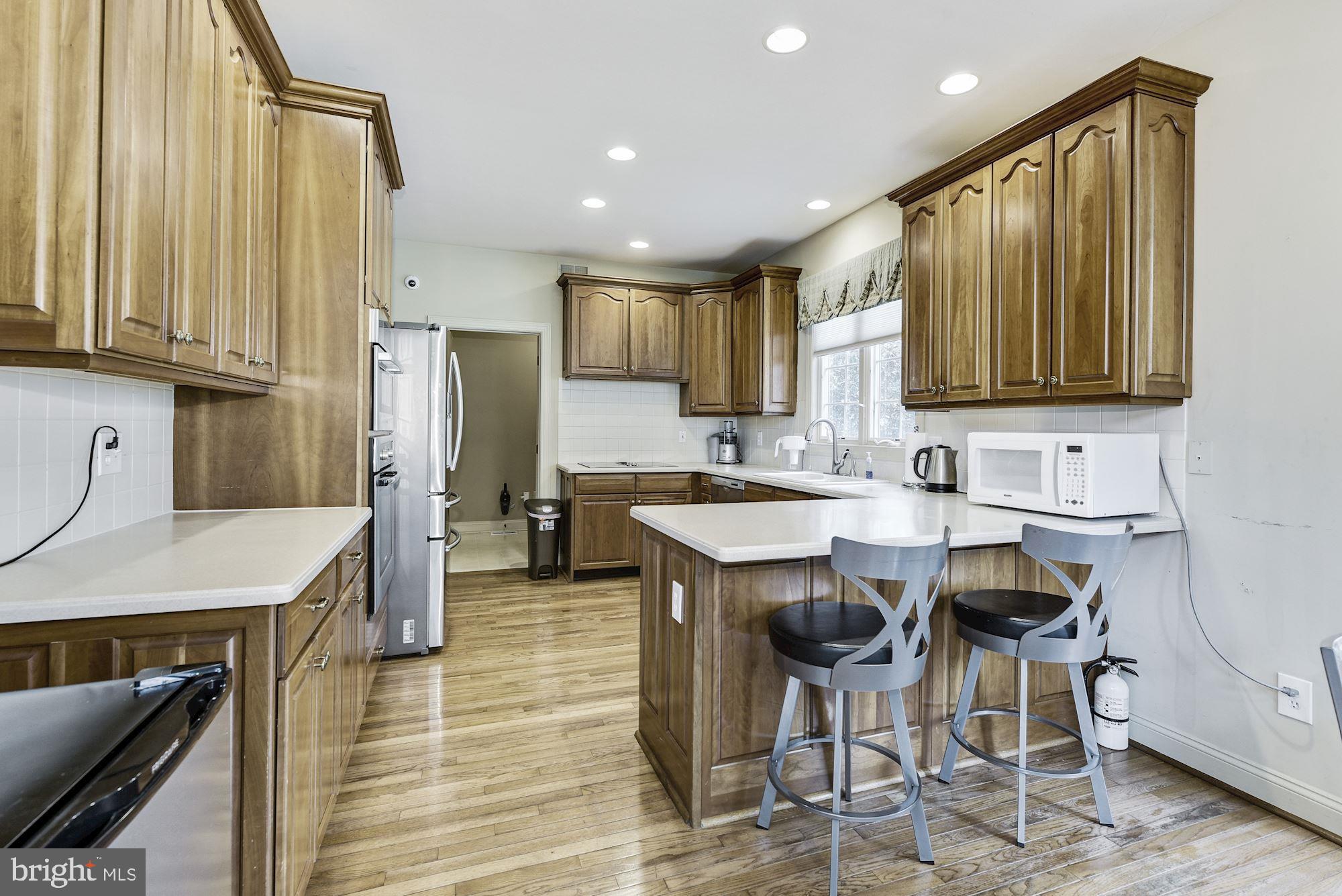 126 Augusta Drive Moorestown, NJ 08057 - Photo 9 of 33 a kitchen with stainless steel appliances granite countertop wooden cabinets a sink stove and a refrigerator