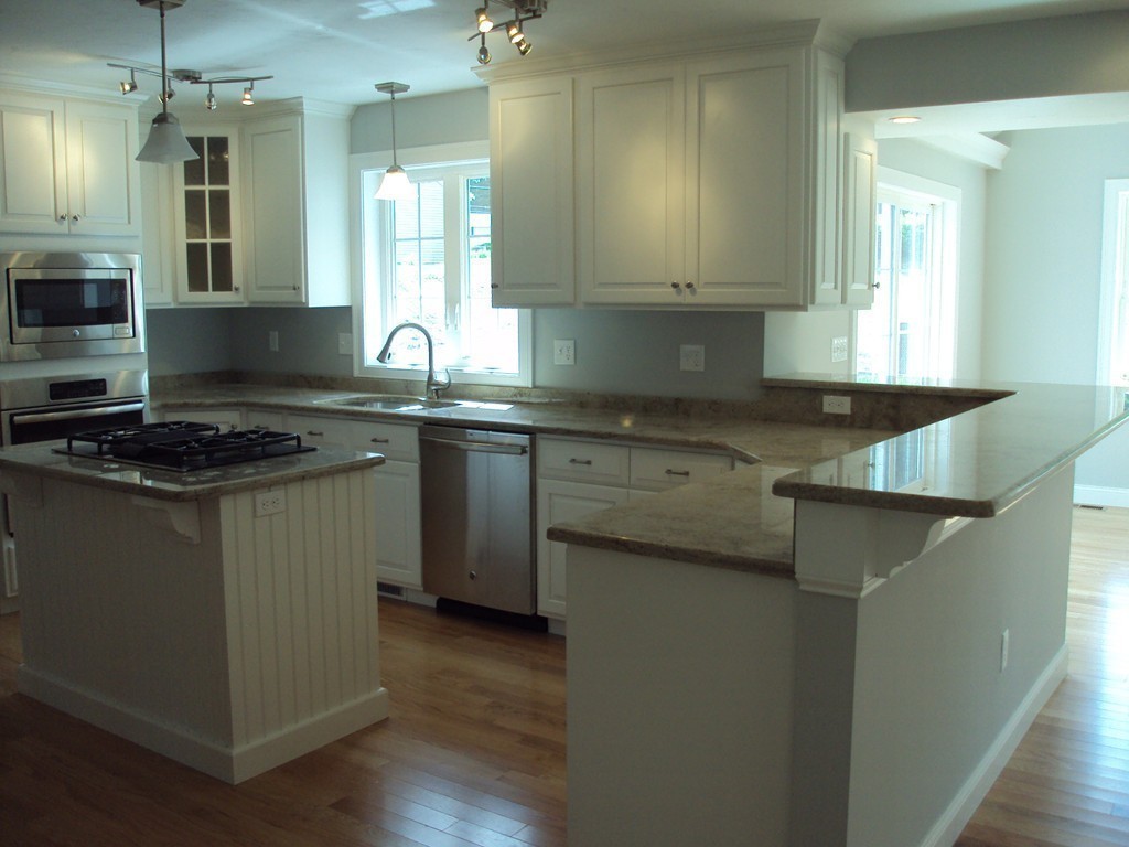 20 Boston Road Sutton, MA 01590 - Photo 9 of 14 a kitchen with granite countertop a sink a stove and cabinets