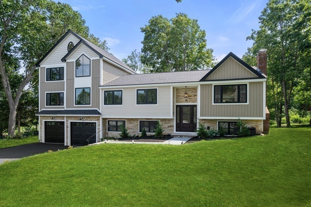 35 Longmeadow Road Medfield, MA 02052 - Photo 1 of 41 a front view of a house with a yard and garage