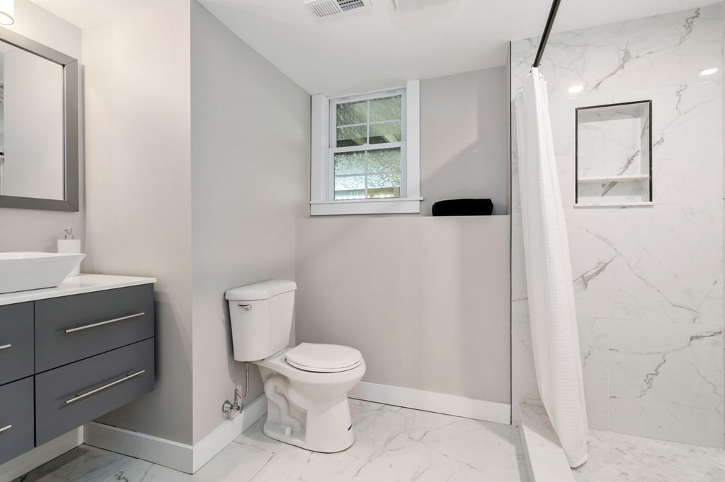 35 Longmeadow Road Medfield, MA 02052 - Photo 36 of 41 a white toilet sitting next to a bathroom sink