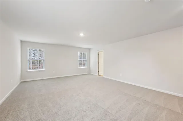 a bedroom with furniture and a flat screen tv