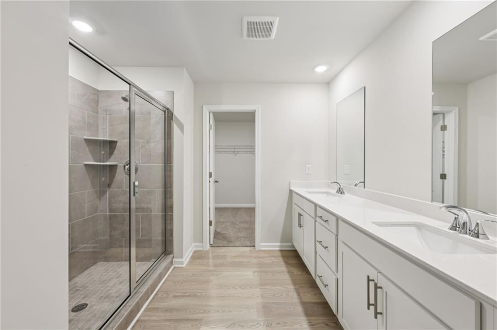 471 Tallulah Lane Grayson, GA 30017 - Photo 25 of 38 a bathroom with a double vanity sink and mirror