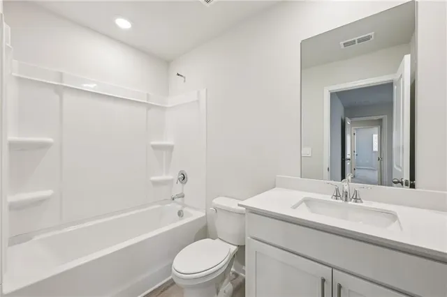 a bathroom with a double vanity sink toilet and a mirror